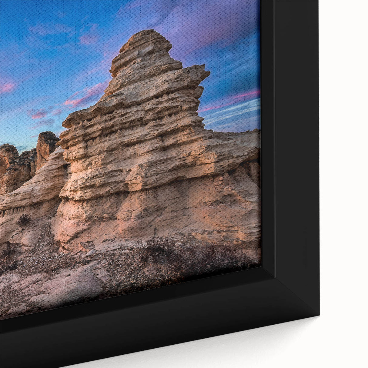 A close-up of extra large black wall art featuring a textured, colorful Kansas scenery on a framed canvas.