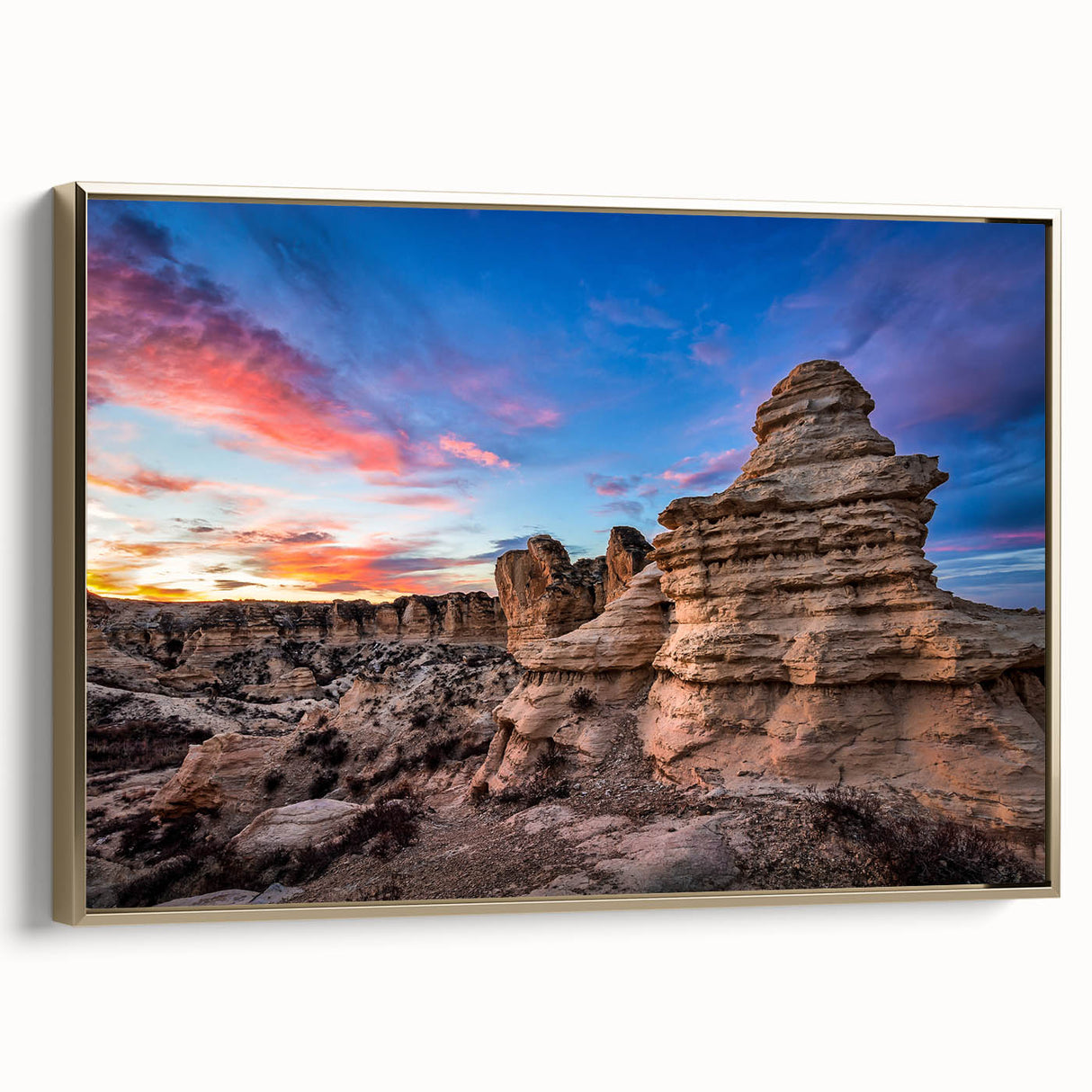 Framed canvas of a Kansas landscape in muted gold and black tones, ideal for bedroom wall decor.