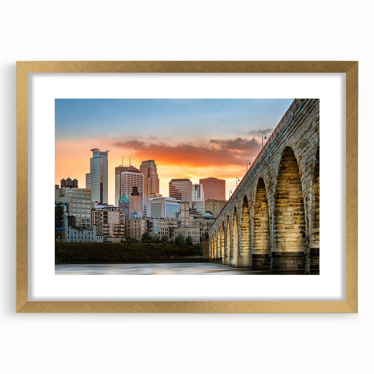 Abstract art print of Minneapolis skyline in textured gold frame, featuring muted earth tones.