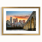 Abstract art print of Minneapolis skyline in textured gold frame, featuring muted earth tones.