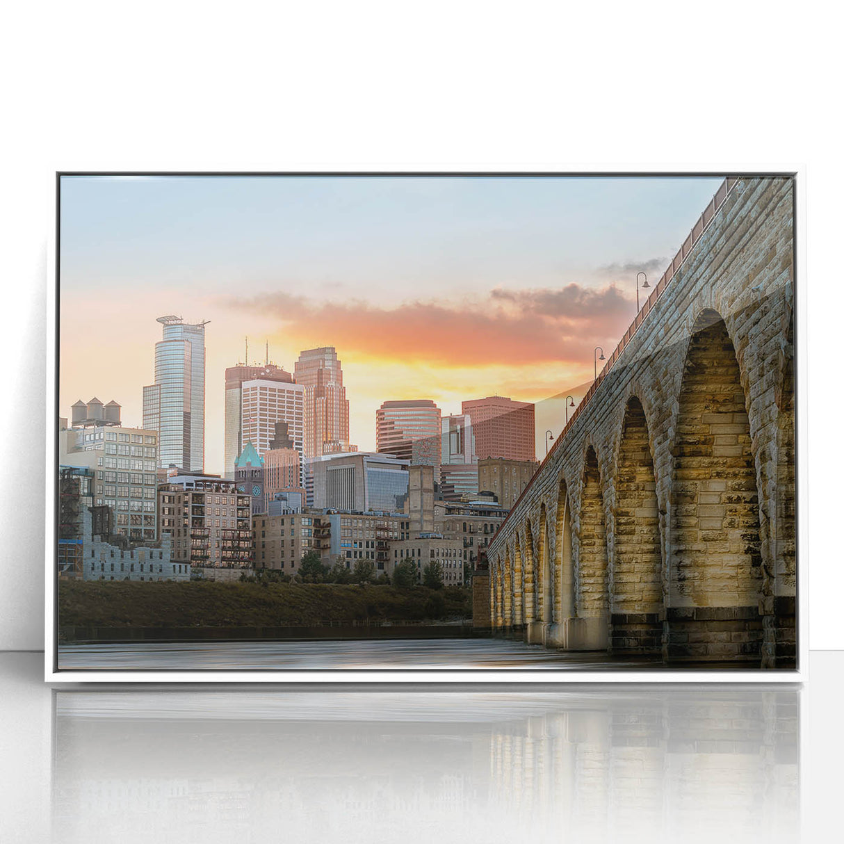 Acrylic print of Minneapolis skyline in muted gray and white tones, framed in white, suitable for modern nursery decor.
