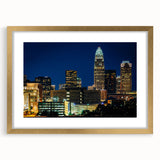 Extra large abstract art print of Charlotte skyline in gold frame, featuring textured brush strokes in muted colors.