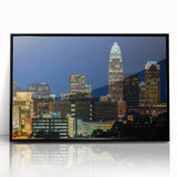 Large abstract wall art depicting the Charlotte skyline in muted gray and blue tones on a framed acrylic.