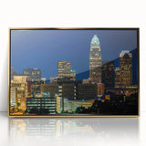 Framed acrylic print of Charlotte skyline in muted gold and blue tones, ideal for modern art wall decor.