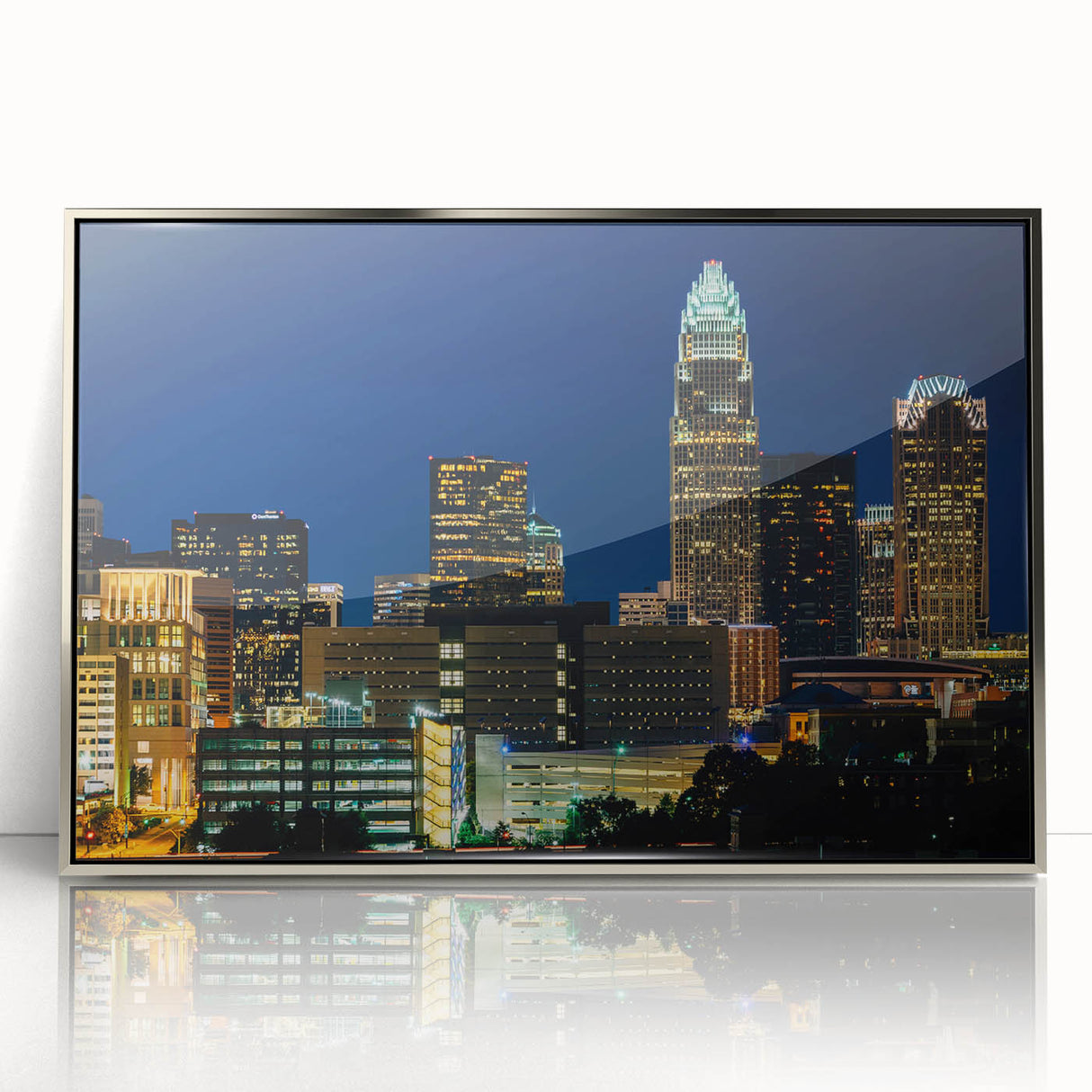 Mid-century modernist art depicting the Charlotte skyline in muted blues and grays, acrylic print framed in silver.