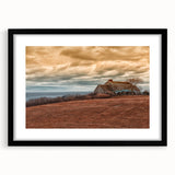 Abstract art print of a colorful, textured scene, framed in black, ideal for living room decor.