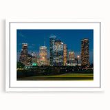 Abstract art print of Houston skyline in muted blue and gray tones, framed with a white mat, suitable for dining room decor.
