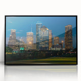 Large abstract wall art depicting the Houston skyline in muted gray and blue tones on a black framed acrylic.
