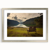 Textured art print of abstract scenic depiction in muted earth tones on a silver-framed mat, ideal for bedroom ambiance.