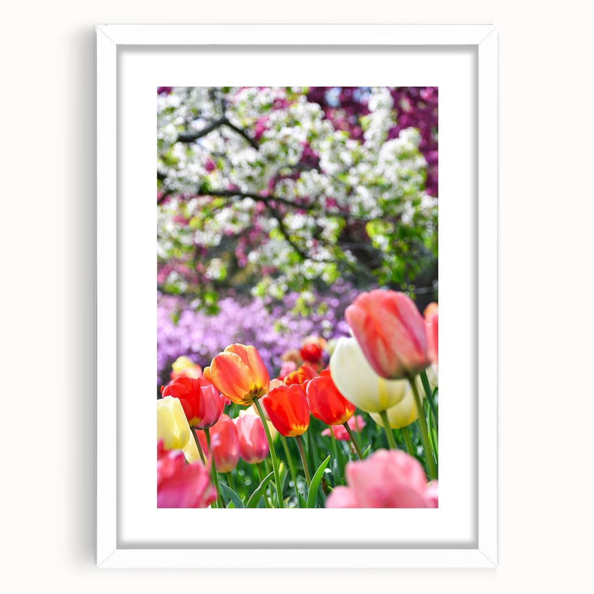Abstract art print depicting spring with soft green and pink tones on a white framed canvas.