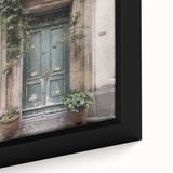 Close-up of a black framed canvas featuring a textured image of a colorful, French door design, ideal for living room decor.