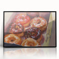 Large abstract wall art featuring assorted pastries in muted colors, framed in black acrylic, suitable for a modern kitchen.