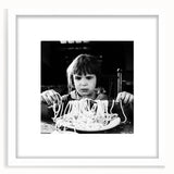 Abstract art prints featuring silhouetted figures and food motifs in black and white, framed with a white mat.