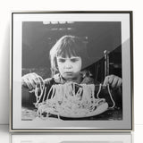 Mid-century modernist art depicting abstract food and people in muted colors on a silver-framed acrylic print.