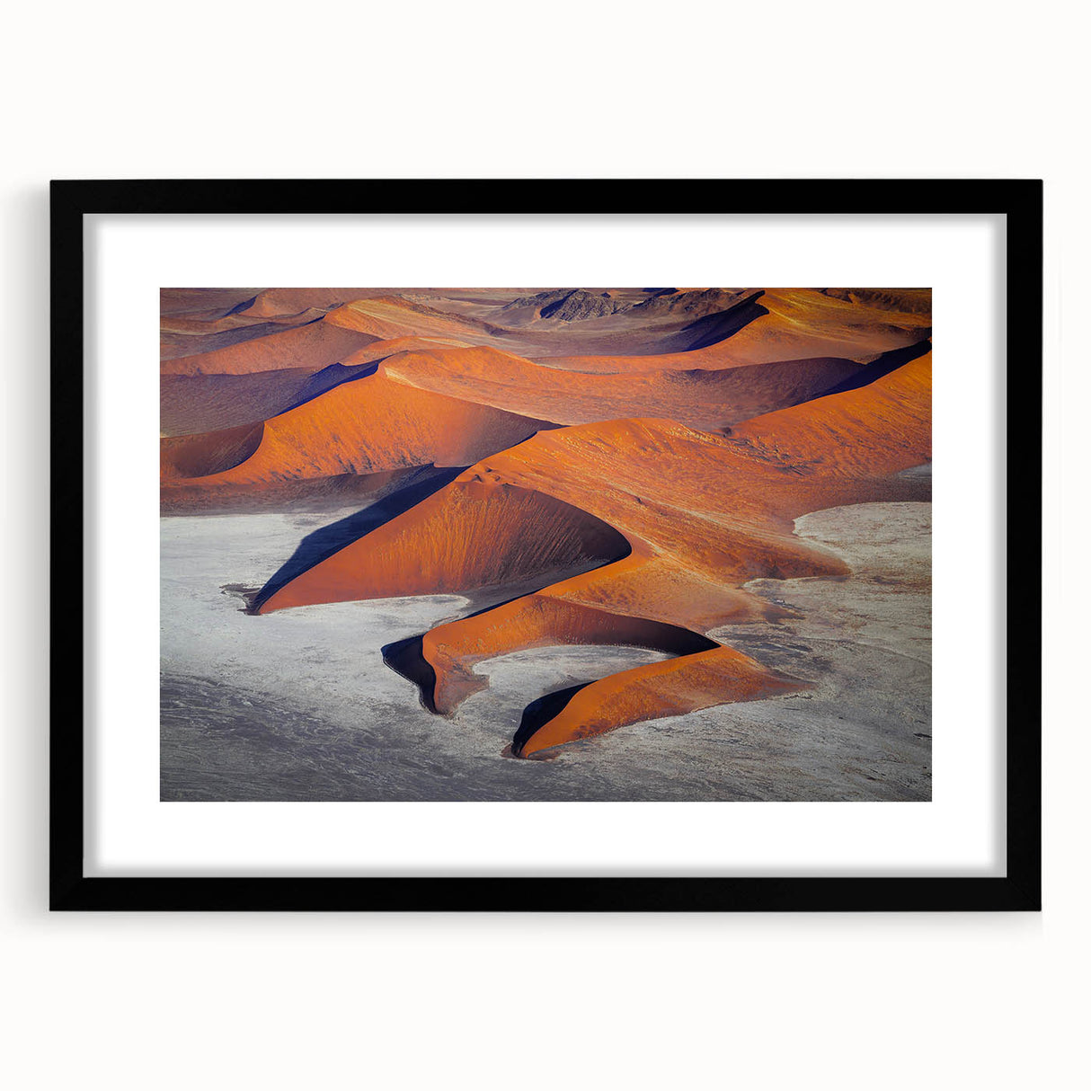 Extra large abstract art print of a colorful Namibian landscape on textured canvas, framed in black.