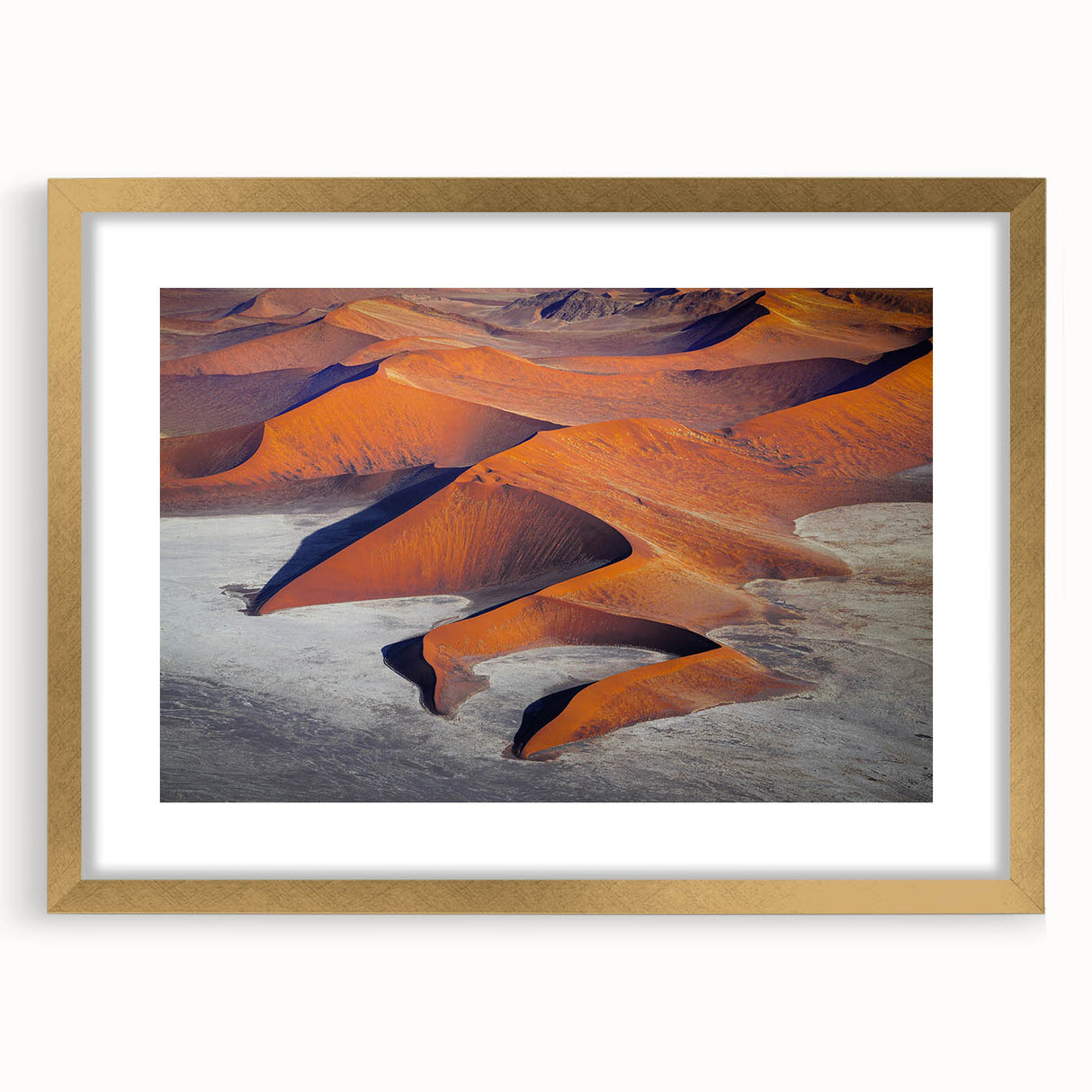 Textured art print of an abstract Namibian landscape in gold frame, ideal for bedroom wall decor.