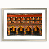 Textured abstract art print of a Bhutanese landscape in muted earth tones, framed with a silver mat.