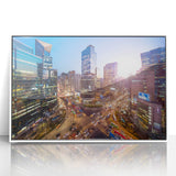 Acrylic print of Seoul skyline in muted gray and blue tones, framed in white, suitable for modern art wall decor.