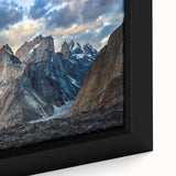 Close-up of black wall art featuring a textured, colorful Pakistani landscape on a framed canvas.