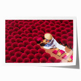 Rolled print of a Vietnamese landscape featuring lush greenery and a river, in muted earth tones.