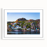 Abstract art print of a Newfoundland scenery in muted blue and gray tones, framed with a white mat.