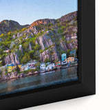 Close-up of a textured black wall art featuring colorful Newfoundland scenery on a framed canvas.