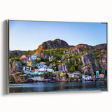 Framed canvas featuring a vintage-style landscape painting of Newfoundland, with muted earth tones and silver frame.