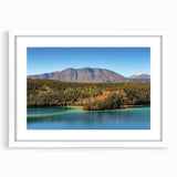 Abstract art print of the Yukon landscape in muted blues and greens on a framed white mat, suitable for dining room decor.