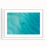 Textured abstract art print of Caribbean scenery in muted blue and green tones, framed with a white mat.