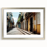 Extra large abstract art print depicting a Caribbean scenery in vibrant blue and green hues, framed with a silver mat.