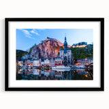 Abstract art print featuring a colorful, textured depiction of a European scenery in a black frame with mat.