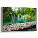 Framed canvas featuring a vintage-style landscape painting of a Croatian coastal scene with colorful buildings and a black…