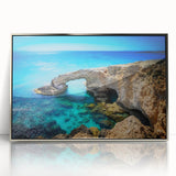 Large art print of a European Cyprus landscape in muted earth tones on a silver-framed acrylic.