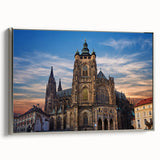 Framed canvas of a vintage-style Prague landscape painting with a silver frame, featuring colorful art on a black background.