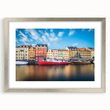 Extra large abstract art print of a European scenery in silver frame, featuring textured designs in muted earth tones.