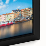 Close-up of extra large framed canvas featuring a textured depiction of a European scenery in black with colorful accents.