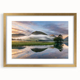 Abstract art print of Cumbria's landscape in muted green and blue tones, framed in gold, suitable for dining room decor.