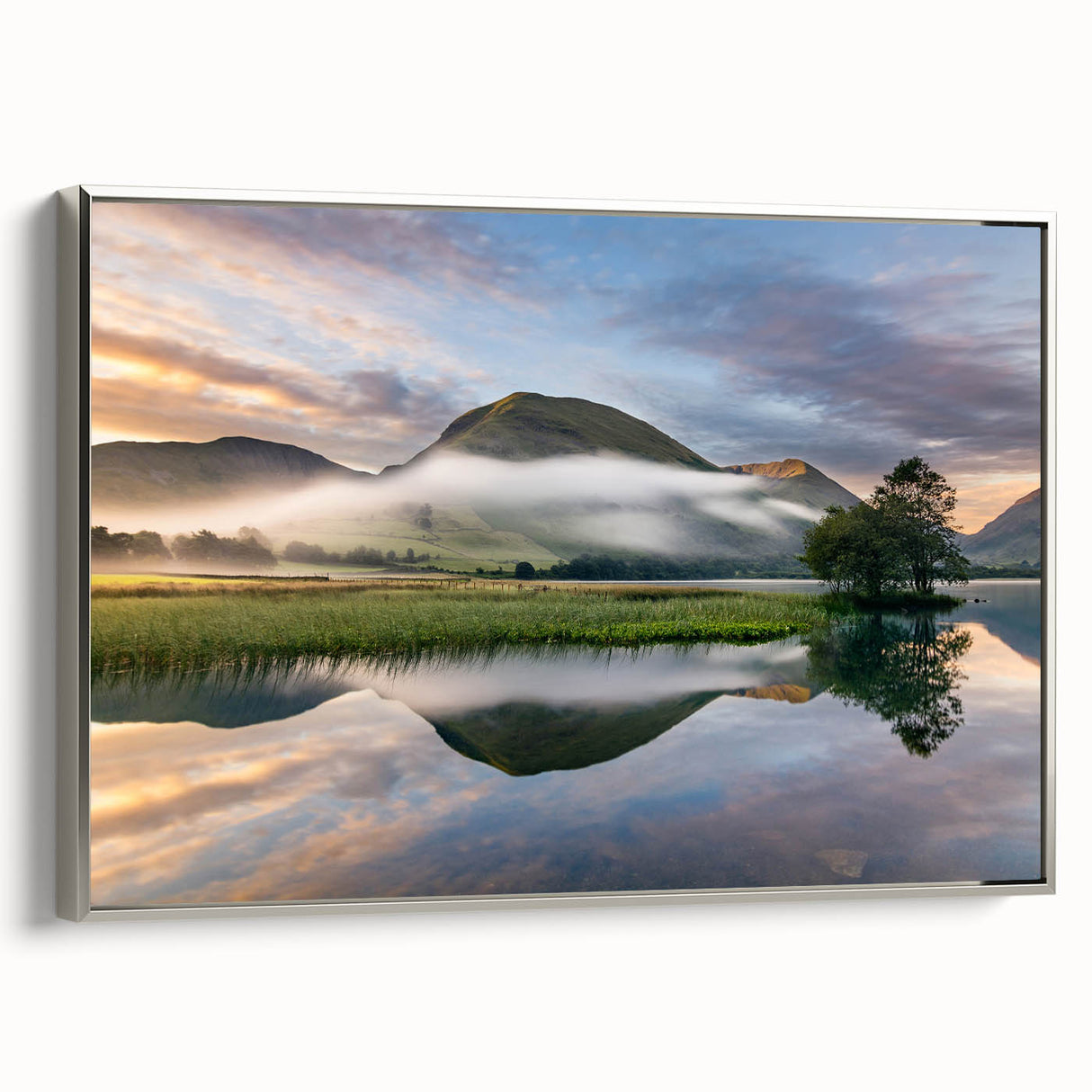 Landscape art painting of Cumbria, England, featuring colorful fields under a cloudy sky, printed on a silver-framed canvas.