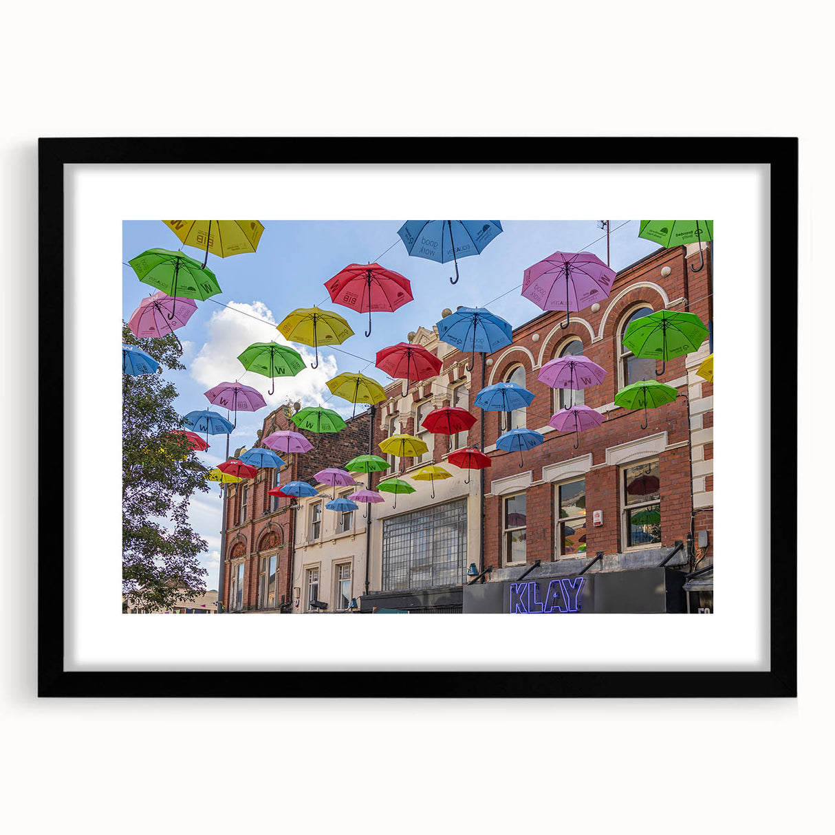 Extra large abstract art print of Piccadilly, England, featuring vibrant colors and a textured design on a framed black mat.