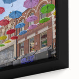Close-up of black wall art featuring a textured, colorful depiction of Piccadilly, England on a framed canvas.
