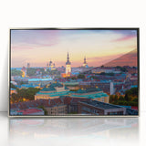 A large art print of a European Estonian scenery in muted green and blue tones, framed in silver acrylic.