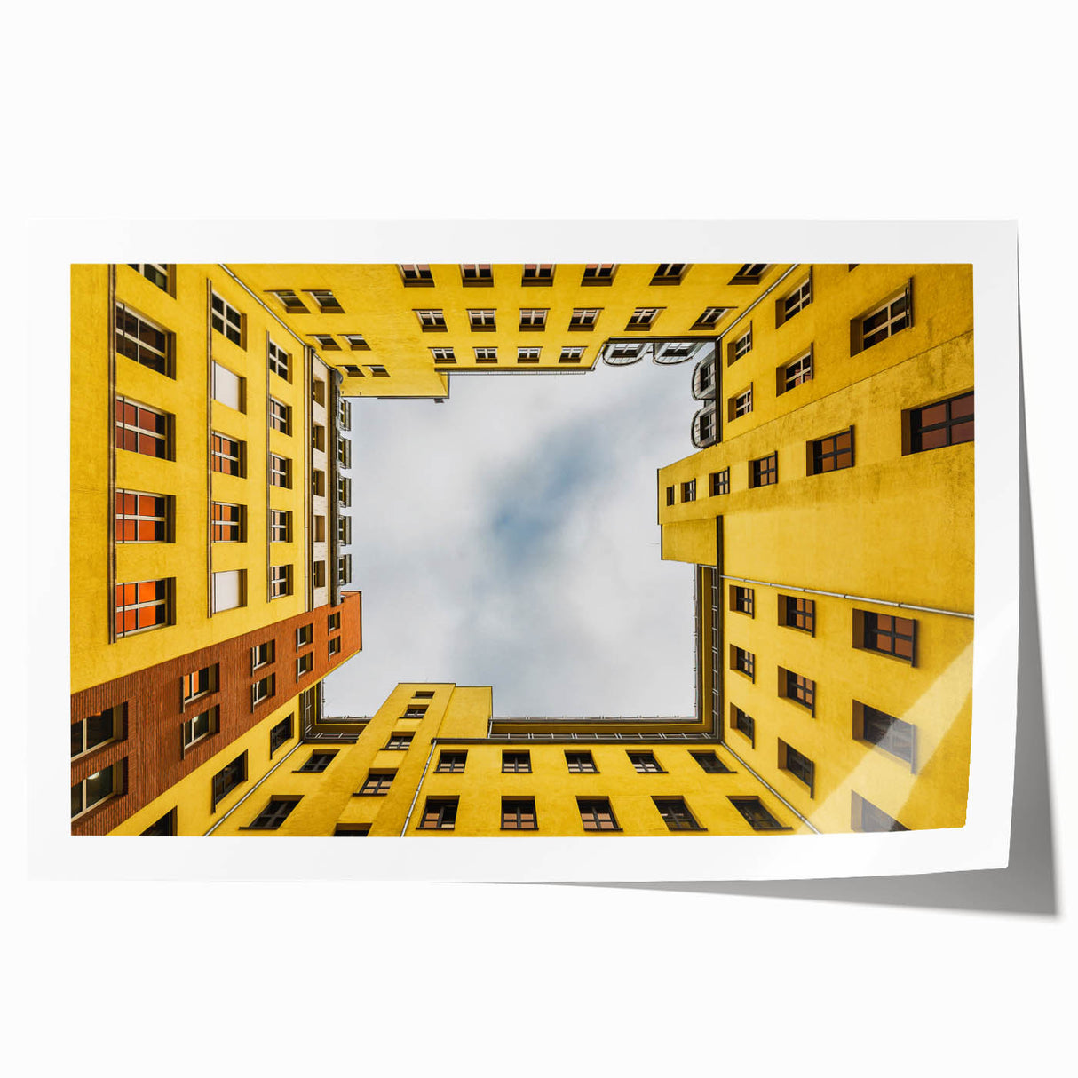 Rolled print of Berlin scenery featuring soft floral elements and muted green and pink hues.