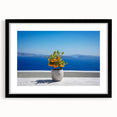 Extra large abstract art print of Santorini with vibrant blue and white palette, framed in black.