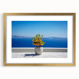 Abstract art print of Santorini with blue and white tones on a gold-framed mat, ideal for bedroom or dining room decor.