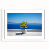 Textured art print of Santorini with abstract white and blue tones in a white frame, suitable for bedroom decor.