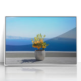 Mid-century modernist art depicting Santorini with white buildings and blue roofs on framed acrylic.