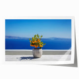 Rolled print of Santorini scenery with white buildings and blue domes against a clear sky, ideal for art wall dining room.