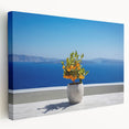 Large art print of Santorini landscape on stretched canvas, showcasing white buildings and blue domes against a clear sky.