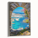 Framed canvas landscape art painting depicting a scenic view of a Greek village with vibrant colors and silver frame.