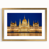 Abstract art print of a European cityscape in muted gold and blue tones, framed with a gold mat, ideal for dining room decor.